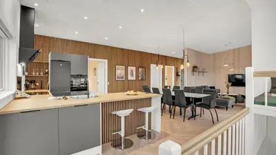 a kitchen and living room with a table and chairs at Villavilla 603 - Hostrup Strand, Limfjorden in Spottrup