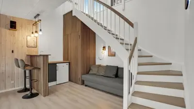 a staircase leading up to a living room with a couch at Villavilla 603 - Hostrup Strand, Limfjorden in Spottrup
