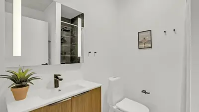 a bathroom with a sink and a toilet and a mirror at Villavilla 603 - Hostrup Strand, Limfjorden in Spottrup
