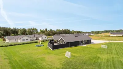 a house with a large yard with a frisbee at Villavilla 547 - Hostrup Strand, Limfjorden in Spottrup