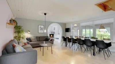 a living room with a couch and a table and chairs at Villavilla 373 - Glyngøre, Limfjorden in Roslev