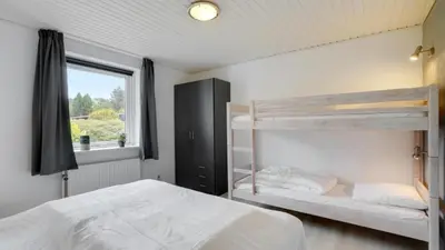 a bedroom with two bunk beds and a window at Villavilla 373 - Glyngøre, Limfjorden in Roslev