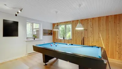 a pool table in a room with wooden walls at Villavilla 373 - Glyngøre, Limfjorden in Roslev