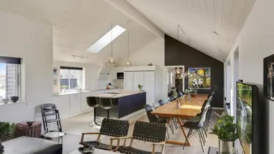 a kitchen and dining room with a table and chairs at Villavilla 476 - Vorupør, Nordjylland in Thisted