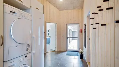 a laundry room with a washer and dryer at Villavilla 431 - Hostrup Strand, Limfjorden in Spottrup