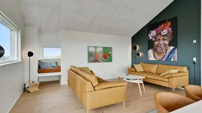 a living room with two couches and a painting of an older woman at Villavilla 514 - Grønhøj, Nordjylland in Løkken