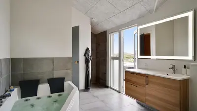 a bathroom with a bath tub and a sink at Villavilla 514 - Grønhøj, Nordjylland in Løkken