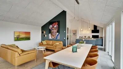 a kitchen and living room with a table and chairs at Villavilla 514 - Grønhøj, Nordjylland in Løkken