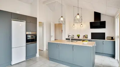 a kitchen with blue cabinets and a counter top at Villavilla 514 - Grønhøj, Nordjylland in Løkken