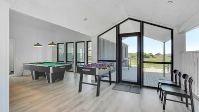 a billiard room with a pool table and chairs at Villavilla 909 - Blokhus, Nordjylland in Blokhus