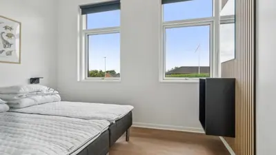 a bedroom with a bed and a large window at Villavilla 645 - Hostrup Strand, Limfjorden in Spottrup