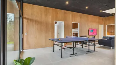 a ping pong table in a room with wooden walls at Villavilla 684 - Virksund, Limfjorden in Højslev