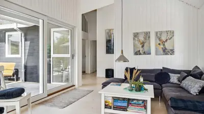 a living room with a couch and a table at Villavilla 691 - Blokhus, Nordjylland in Blokhus