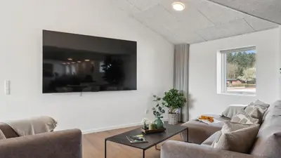 a living room with two couches and a table at Villavilla 680 - Blokhus, Nordjylland in Blokhus