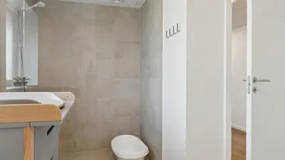 a bathroom with a toilet and a sink and a shower at Villavilla 680 - Blokhus, Nordjylland in Blokhus