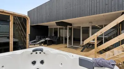 a bath tub sitting on the deck of a house at Villavilla 680 - Blokhus, Nordjylland in Blokhus