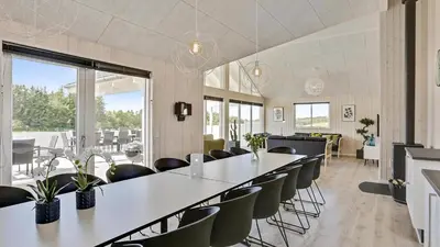 a large room with a long table and chairs at Villavilla 405 - Hostrup Strand, Limfjorden in Spottrup