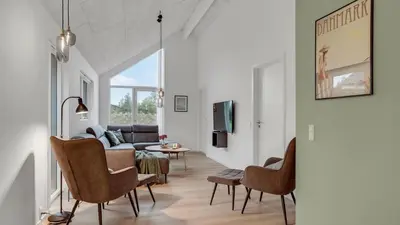 a living room with a couch and chairs at Villavilla 692 - Blokhus, Nordjylland in Blokhus