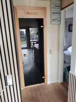 a hallway with a door to a room with a bedroom at Peaceful Holiday Home With Pool Summer And Spa in Farsø