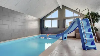a indoor swimming pool with a slide in a room at Villavilla 546 - Hostrup Strand, Limfjorden in Spottrup