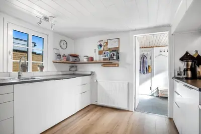 a kitchen with white cabinets and a counter top at 730-Thyboron-Manovej-9 in Thyborøn