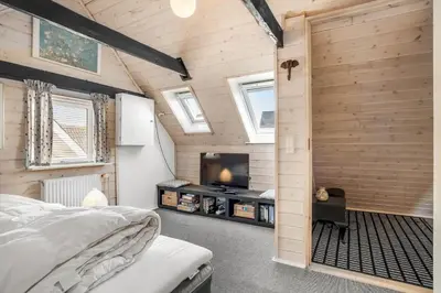 a bedroom with a bed and a tv in a room at 730-Thyboron-Manovej-9 in Thyborøn