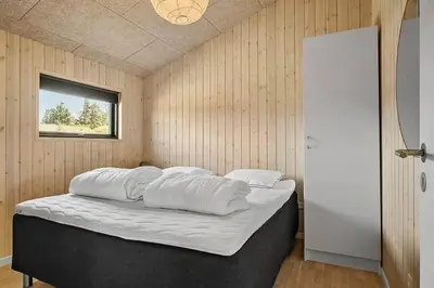 a bedroom with a bed with four pillows on it at BL1150-Saltum-Tolhoj-46 in Saltum