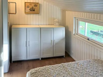 a bedroom with white cabinets and a window at 6 person holiday home in Roslev in Roslev