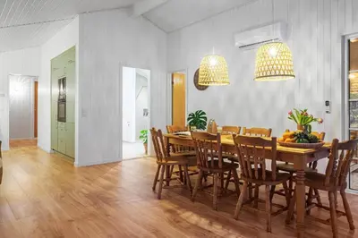 a dining room with a wooden table and chairs at BL1148-Blokhus-Havorns-Alle-6 in Blokhus