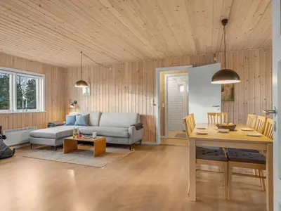 a living room with a couch and a table at Holiday Home Ovine - 900m from the sea by Interhome in Thisted