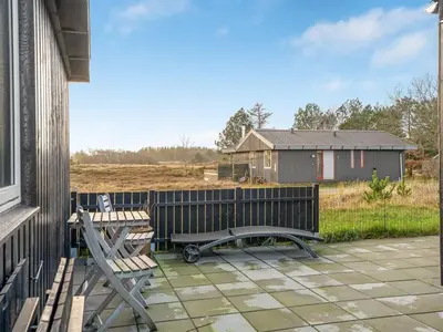 a patio with two benches and a fence at Holiday Home Ovine - 900m from the sea by Interhome in Thisted