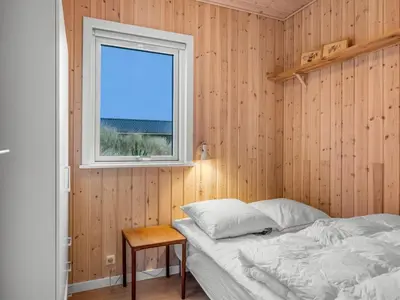 a bedroom with a bed and a window at Holiday Home Ovine - 900m from the sea by Interhome in Thisted
