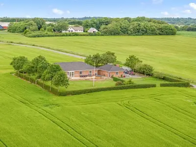 an aerial view of a house in a green field at Holiday Home Erja - 300m to the fjord by Interhome in Roslev