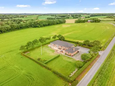 an aerial view of a large house in a field at Holiday Home Erja - 300m to the fjord by Interhome in Roslev