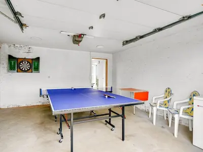 a ping pong table in a room with chairs at Holiday Home Erja - 300m to the fjord by Interhome in Roslev