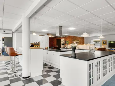 a kitchen with white cabinets and a checkered floor at Holiday Home Borjana - 500m to the fjord by Interhome in Fur