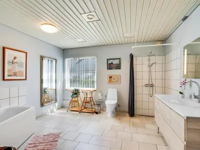 a bathroom with a tub and a toilet and a sink at Holiday Home Borjana - 500m to the fjord by Interhome in Fur