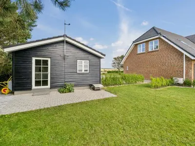 a house with a grey shed in a yard at Holiday Home Fridhild - 150m to the fjord by Interhome in Redsted