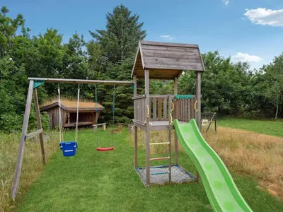 a playground with a slide and a play structure at Holiday Home Muriel - 1-6km from the sea by Interhome in Blokhus