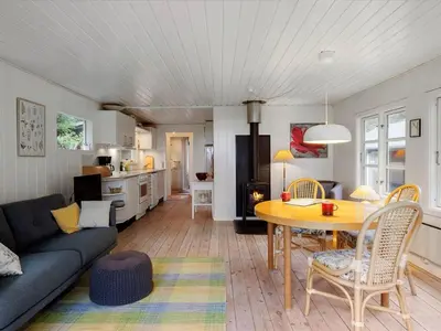 a living room with a couch and a table at Holiday Home Patti - 700m from the sea by Interhome in Blokhus