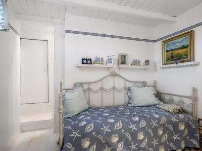 a bedroom with a bed with a blue comforter at Holiday Home Åsta - 200m from the sea by Interhome in Saltum