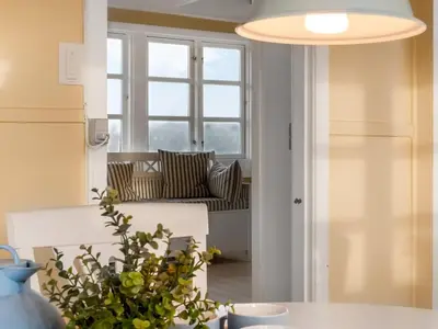 a living room with a couch and a table at Holiday Home Åsta - 200m from the sea by Interhome in Saltum
