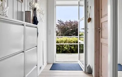 a hallway with a door leading to a patio at 2 Bedroom Cozy Home In Roslev in Roslev