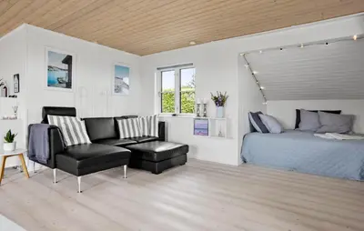 a bedroom with a bed and a chair at 2 Bedroom Cozy Home In Roslev in Roslev