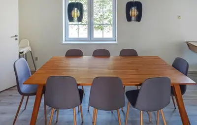 a dining room table with six chairs around it at 4 Bedroom Beautiful Home In Farsø in Farsø