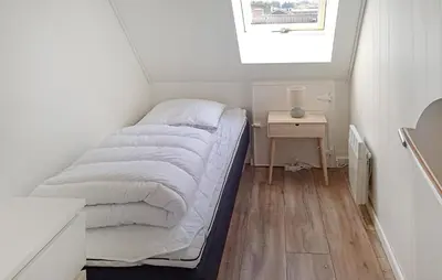 a small bed in a small room with a window at 4 Bedroom Beautiful Home In Farsø in Farsø