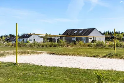 a house in a field next to a beach at JB374-Brovst-Kronvildtvej-222 in Tranum Strand