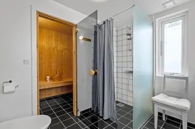 a bathroom with a shower and a toilet and a sink at JB374-Brovst-Kronvildtvej-222 in Tranum Strand