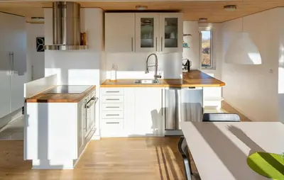 a kitchen with white cabinets and a sink at 3 Bedroom Amazing Home In Brovst in Brovst