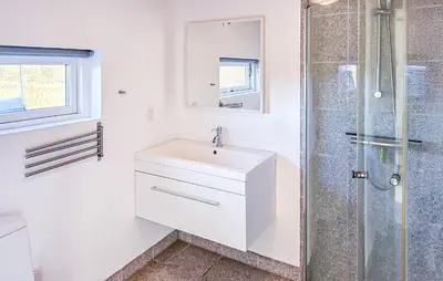 a white bathroom with a sink and a shower at 3 Bedroom Amazing Home In Brovst in Brovst